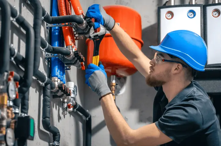 Professional technician installing gas boiler system for government grant program eligibility